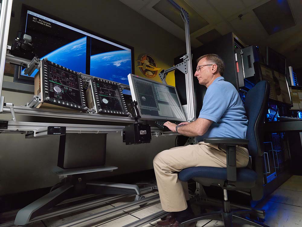 Man working on a guidance control simulator.